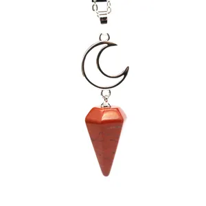 Close-up of natural red stone dowsing pendulum with silver moon charm pendant