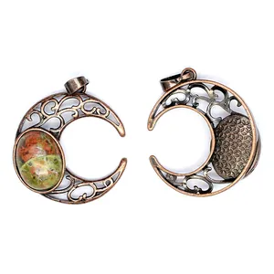 Close-up of vintage style antique copper crescent moon pendant with intricate filigree details