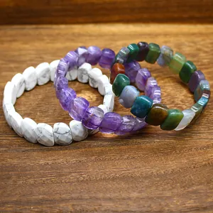 Close-up detail of faceted natural stone bracelets in amethyst, marble, and agate