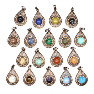 Detailed view of multiple teardrop natural stone pendants with intricate bronze filigree.