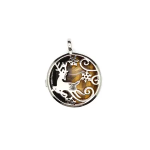Macro view of round silver deer locket pendant featuring a tiger eye stone inlay detail.