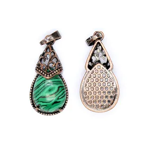 Detailed view of retro malachite-style teardrop pendant with vintage metal casing