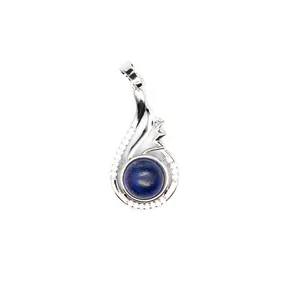 Detailed view of a silver-toned pendant featuring a round blue stone and crystal accents.