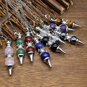 Detail shot of natural 12mm crystal stone pendulums with crown and metal point charms.