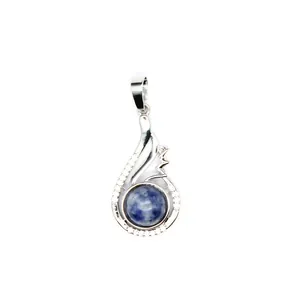 Close-up of elegant blue stone pendant with silver wing-shaped setting and crystal accents