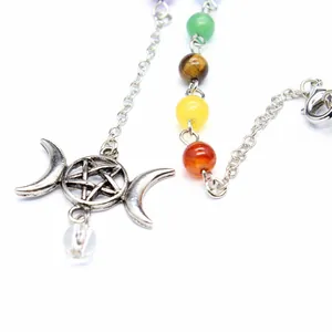 Close-up of chakra stone pendulum necklace with silver triple moon pentagram pendant.