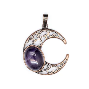 Close-up view of vintage bronze moon pendant featuring an elegant purple oval stone