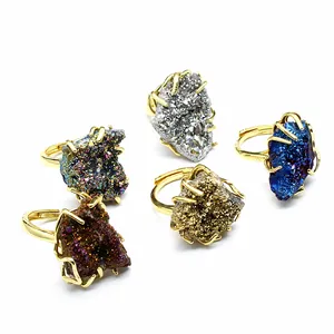 Close-up of five colorful natural druzy crystal cluster rings on gold adjustable bands.