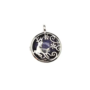 Detailed view of a round silver reindeer pendant with blue goldstone and snowflake
