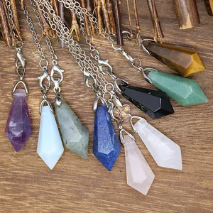 Macro view of various natural stone hexagonal pendulum pendants on wooden background