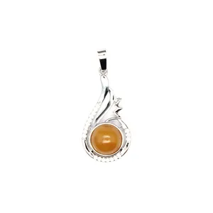 Detailed macro shot of a silver pendant featuring a round yellow aventurine stone