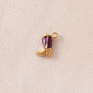 Detailed macro view of a gold and purple enamel cowboy boot charm for DIY jewelry craft