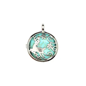 Detailed macro view of a silver reindeer pendant with a turquoise stone inlay