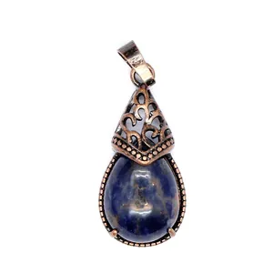 Detail view of a vintage bronze water drop pendant with dark blue natural stone
