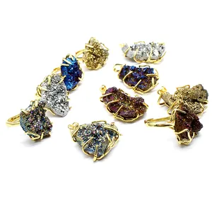 A diverse collection of colorful druzy agate stone rings and pendants on white background