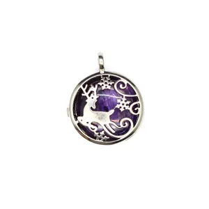 Macro view of a silver-toned reindeer hollow locket pendant with purple crystal insert