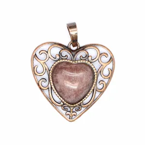 Close-up detail of vintage hollow heart pendant with central red natural stone inlay