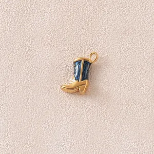 Macro view of a gold and blue enamel cowboy boot charm for custom jewelry DIY projects.