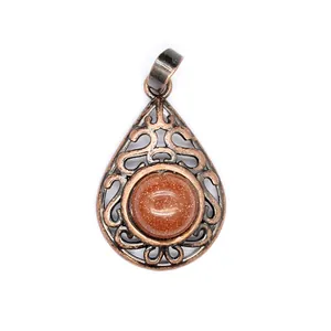 Close-up of hollow water drop pendant with sparkling red goldstone cabochon