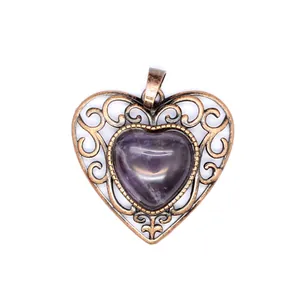 Detailed view of a vintage bronze heart pendant with a purple amethyst-like stone center.