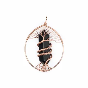 Detailed macro view of handmade wire-wrapped tree of life pendant with black crystal