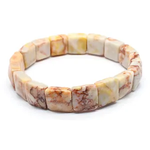 Macro detail view of square faceted marbled natural stone beads on an elastic stretch bracelet