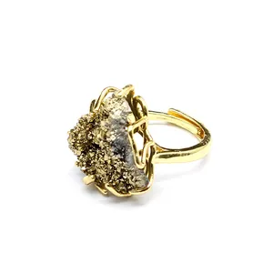 Detailed macro view of natural golden druzy agate crystal cluster on adjustable ring