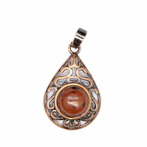 Close-up view of vintage hollow water drop pendant with natural red aventurine stone