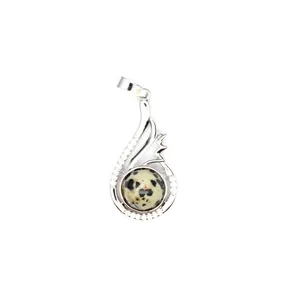 Detailed view of a silver pendant featuring a speckled natural stone and crystals