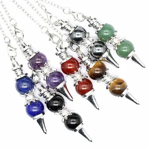Detail view of various 12mm natural stone dowsing pendulums with silver chains