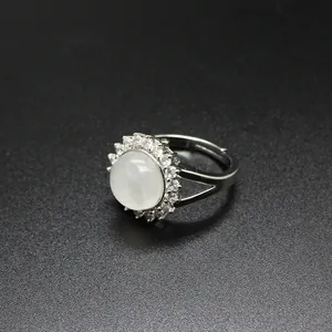 Macro detail of adjustable silver ring with milky white stone and crystal halo