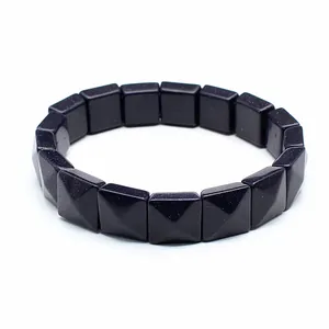 Detailed macro view of a blue goldstone bracelet with faceted square pyramid beads
