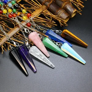 Macro detail of natural stone hexagonal cone pendulums with chakra bead chains