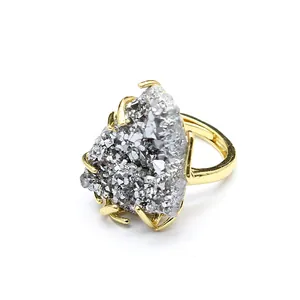 Detail view of a gold-plated ring featuring a natural silver druzy agate crystal