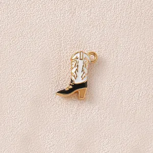 Detailed view of a white and black enamel cowboy boot charm for jewelry making