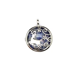 Detail view of silver reindeer and snowflake pendant with blue stone inlay