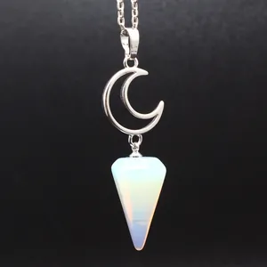 Close-up detail of a silver crescent moon pendant with an opalite cone stone necklace