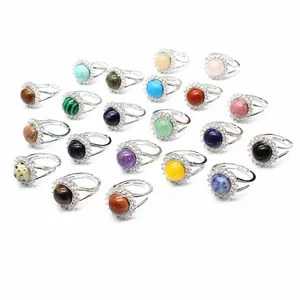 Collection of adjustable gemstone rings with crystal halo and silver-plated bands.