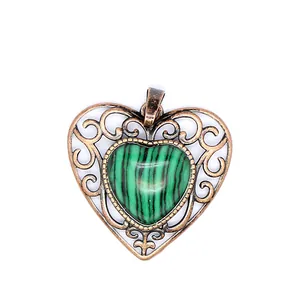 Detailed view of vintage openwork heart pendant with green malachite pattern stone