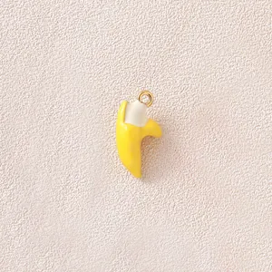 Macro view showing the fine enamel texture of a 3D yellow banana pendant for DIY crafts