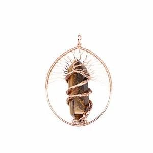 Detailed view of handmade copper wire wrapped tree of life pendant with tiger's eye crystal