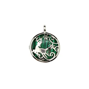 Macro view of silver-tone reindeer pendant with green malachite-pattern background inlay.