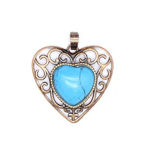 Close-up detail of a vintage bronze openwork heart pendant with blue turquoise stone