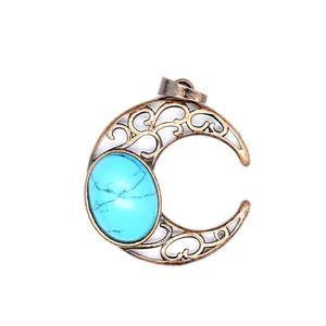 Detailed view of antique bronze crescent moon pendant with turquoise stone inlay