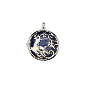 Macro view of silver reindeer snowflake locket pendant with blue lapis lazuli stone.