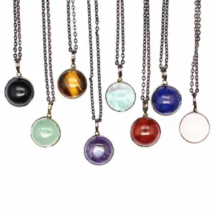 Close-up showing a variety of vintage natural stone pendant necklaces with round beads