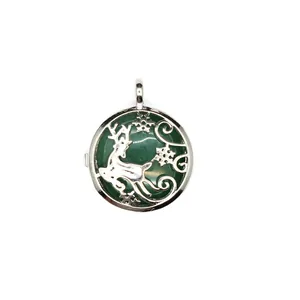 Detailed view of silver reindeer locket pendant with a dark green stone inlay design