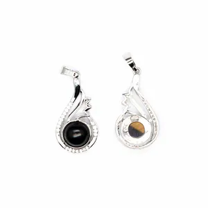 Close-up detail of silver teardrop pendants with black and tiger eye natural stones