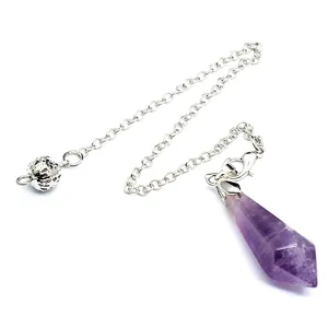 Macro detail of a hexagonal purple amethyst crystal pendulum with silver-plated chain link