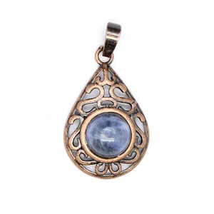 Detailed macro view of vintage copper waterdrop pendant with blue natural stone inlay